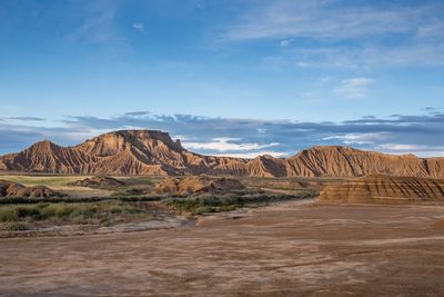 Scenic view of landscape against cloudy sky