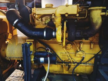 Close-up of yellow machinery in factory