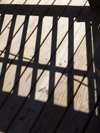 High angle view of shadow on wood