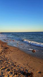 Scenic view of beach against clear sky