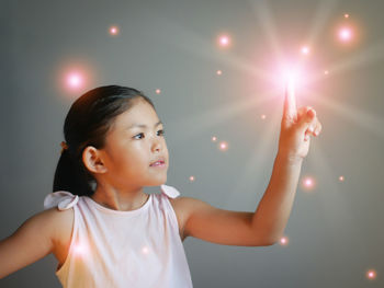 Portrait of young woman holding sparkler at night