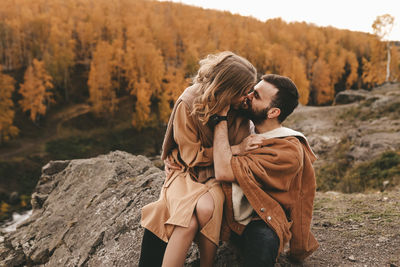 Rear view of couple kissing outdoors