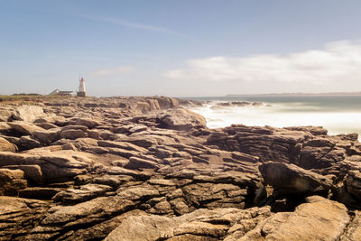 Rocks on beach against sky