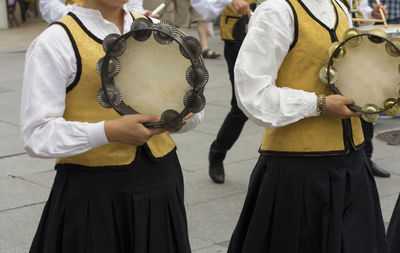 Midsection of women on street during festival