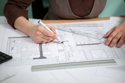 Midsection of businessman working on table