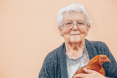 Portrait of senior man holding bird