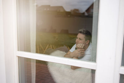 A person looks out the window of their house