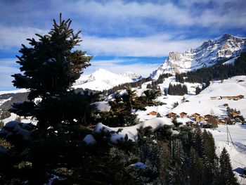 Scenic view of snow covered mountains against sky