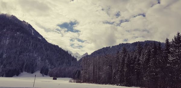 Scenic view of snow covered mountains against sky