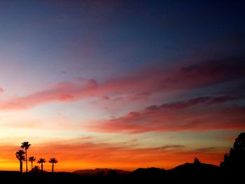 Silhouette of mountain against dramatic sky