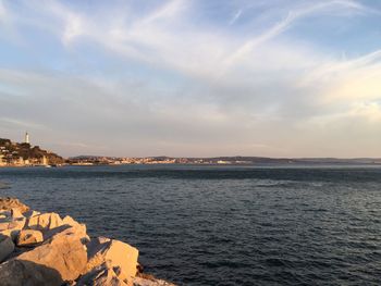 Scenic view of sea against cloudy sky