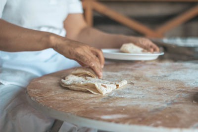 Midsection of man preparing food