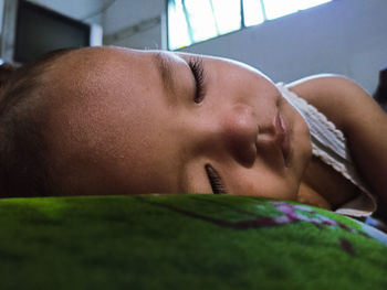 Close-up of baby sleeping on bed