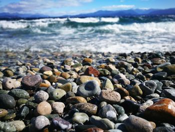 Pebbles at beach on sunny day