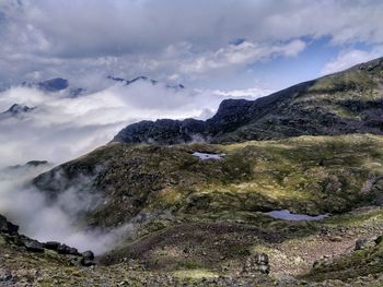 View from above of two glacial lakes and sea of clouds