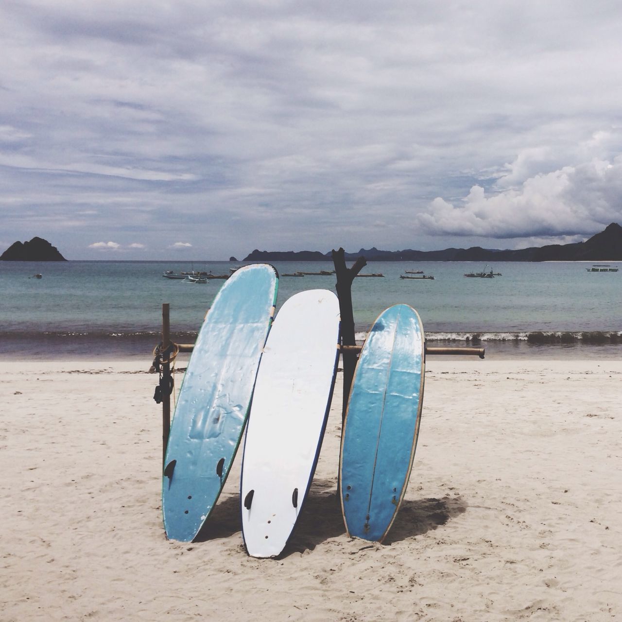 beach, sand, sky, sea, water, shore, tranquility, tranquil scene, cloud - sky, cloud, nature, beauty in nature, scenics, horizon over water, blue, cloudy, day, nautical vessel, outdoors, boat