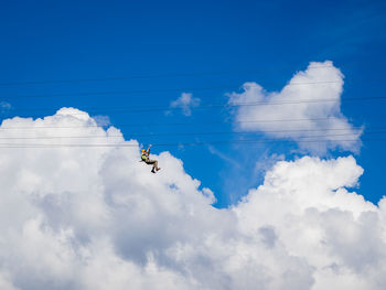 Low angle view of zipline against sky