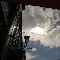 Low angle view of building against cloudy sky
