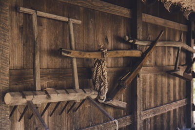 Close-up of rope tied on wooden wall in building