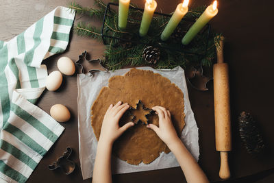 Little girl is baking christmas gingerbread cookies. high quality photo