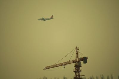 Low angle view of airplane against clear sky