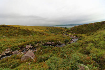 Scenic view of landscape and sea against sky