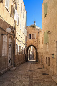 Street amidst buildings in town against sky