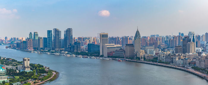 River amidst buildings in city against sky