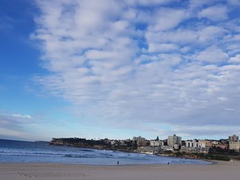 Scenic view of beach against sky in city