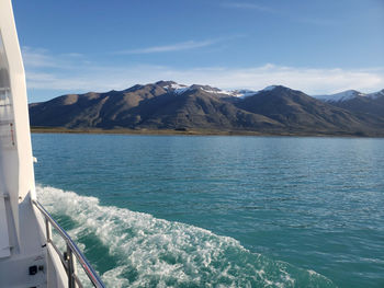 Scenic view of sea and mountains against sky