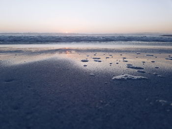 Scenic view of beach against sky during sunset