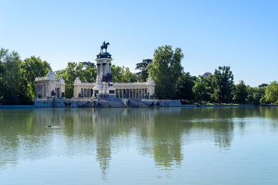 Buen retiro park in madrid, spain. the pond and king alfonso xii monument