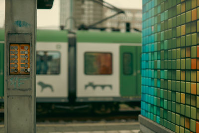 Control panel near a wall at train station with a blurred train in background 