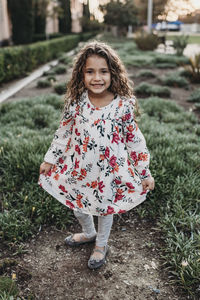 Portrait of young school-aged confident girl smiling at