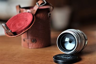 Close-up of camera lens on table