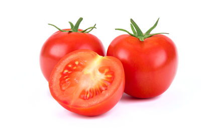 Close-up of tomatoes against white background