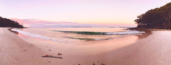 Scenic view of beach against sky during sunset