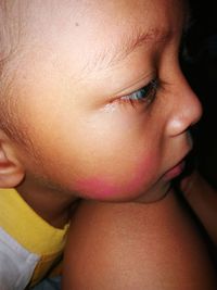 Close-up of baby boy looking away