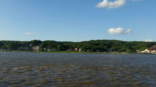 Scenic view of sea and town against sky