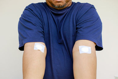 Midsection of man standing against white background