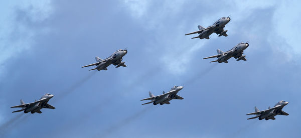 Low angle view of airshow against sky