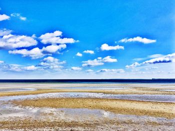 Scenic view of sea against blue sky