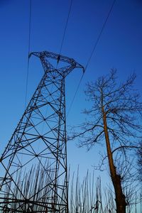 Low angle view of cables against clear blue sky