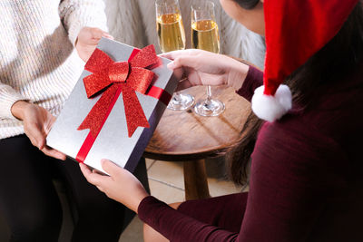 Midsection of woman holding christmas decorations