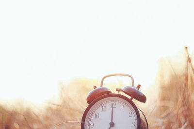 Close-up of clock against clear sky