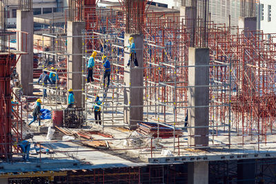 People working at construction site in city