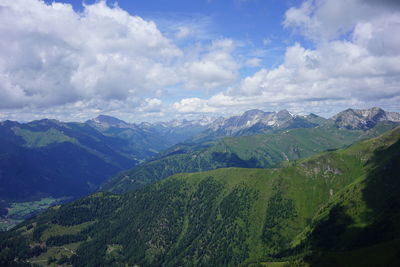 Scenic view of valley and mountains against sky