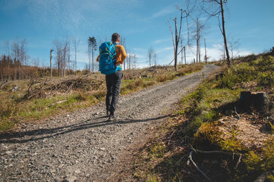 Rear view of man walking on field