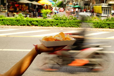 Close-up of hand holding ice cream