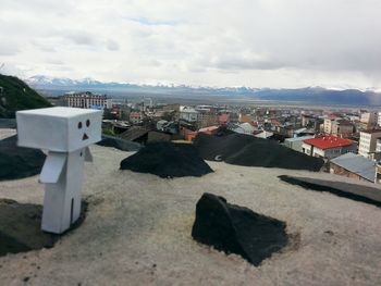 View of cityscape against cloudy sky